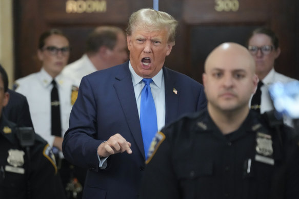 Former president Donald Trump speaks to reporters during a lunch break at the New York Supreme Court.