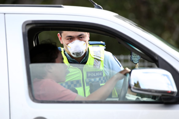 NZ Police stop motorists at a checkpoint in Auckland to ensure residents are complying with the coronavirus lockdown.