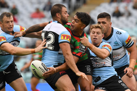 Latrell Mitchell gets an offload away during the win over Cronulla. 