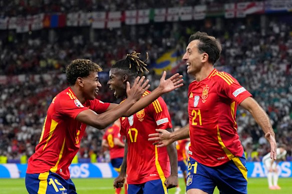 Spain’s Mikel Oyarzabal, right, celebrates with Nico Williams and Lamine Yamal, left, after scoring his side’s second goal during the final match between Spain and England at the Euro 2024 soccer tournament.