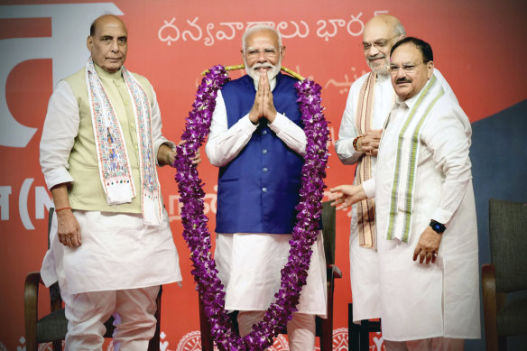 Prime Minister Narendra Modi is garlanded by senior Bharatiya Janata Party leaders Rajnath Singh, left, party President JP Nadda, right, and Amit Shah, at the party headquarters in Delhi.