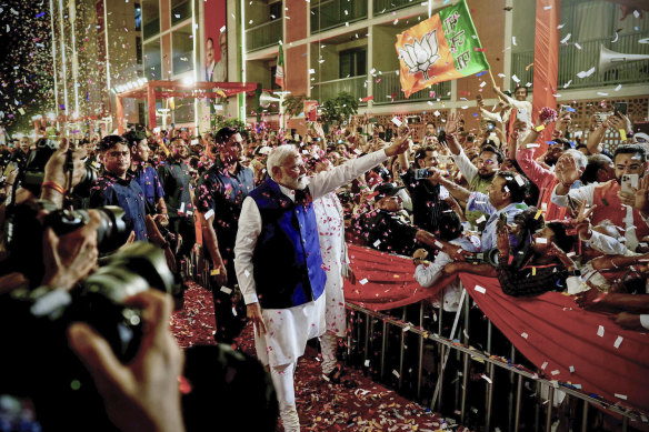 Prime Minister Narendra Modi is greeted by supporters as he arrives at his party’s headquarters in New Delhi.