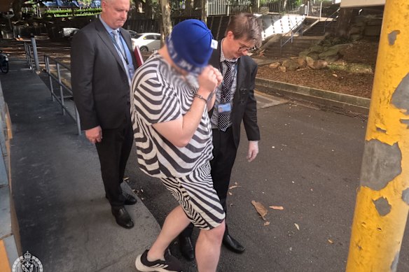 Police escort Germanotta-Mills from a Waterloo home after his arrest.