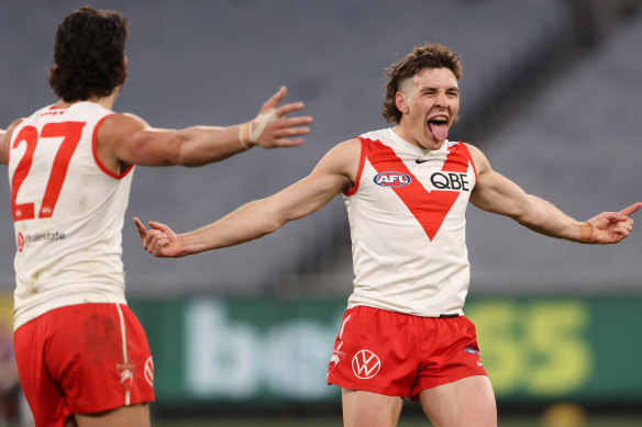 Errol Gulden and the Swans celebrate a goal in round 20.