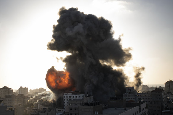 Smoke and fire rises following Israeli airstrikes on a building in Gaza City on Wednesday.