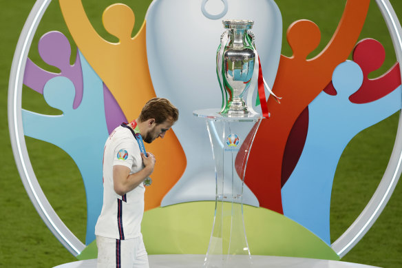 So close, but so far: Harry Kane walks past the trophy after losing the Euro 2020 final on penalties.