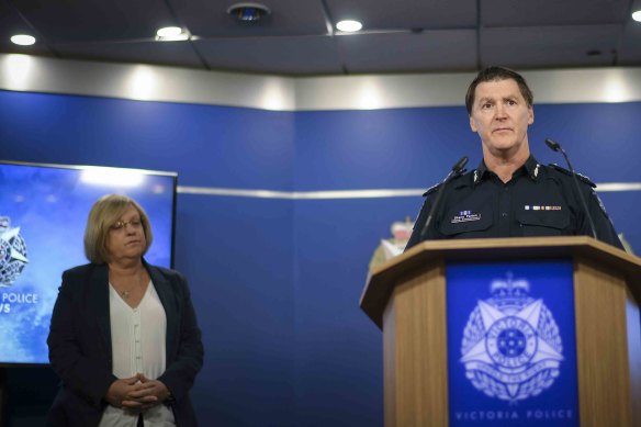 Police Minister Lisa Neville watches as Deputy Commissioner Shane Patton addresses the media on Tuesday.