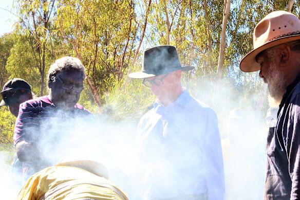 Federal Court Justice Stephen Burley (centre) visited Yindjibarndi country before handing down his native title ruling during his at Bangkangarra via a smoking ceremony, by (L-R) Angus Mack, Stanley Warrie and Michael Woodley.