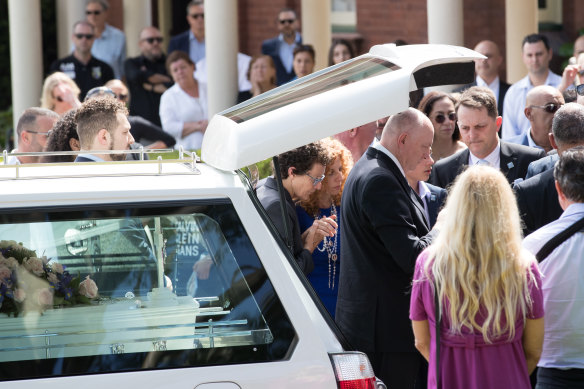 Bridget Sakr (centre in blue), the mother of 11-year-old Veronique Sakr who was killed by an alleged drunk driver, is supported by mourners as she arrives at her daughter's funeral at Santa Sabina College Chapel in Strathfield.