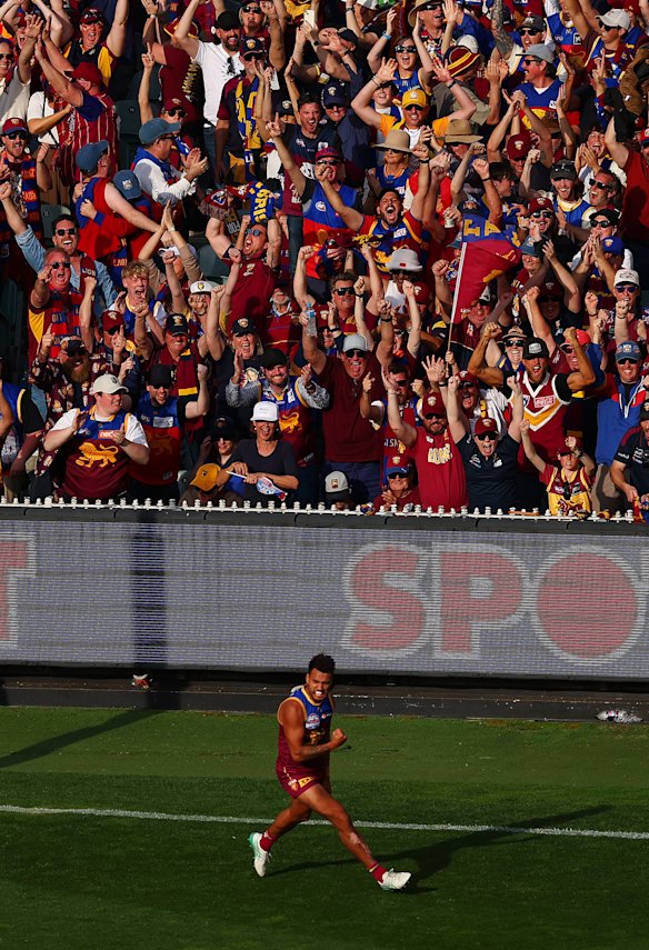 Lions fans react as Callum Ah Chee of the Lions celebrates a goal.