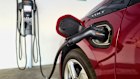 A hybrid car at a charging station.