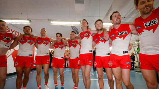 Errol Gulden (in the blue boots) as the Swans sing their team song after beating the Giants earlier this month.