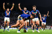 Jesse Arthars and his Warriors teammates celebrate a try in the 20-point win over Wests Tigers.
