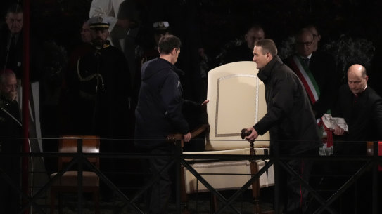 Vatican ushers carry away the Pope Francis’ chair prior to the start of the Via Crucis (Way of the Cross) at the Colosseum on Good Friday, in Rome.
