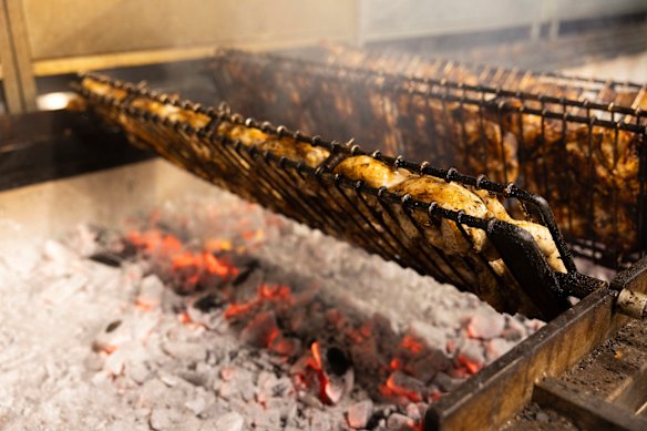 Chickens are grilled over hot coals at the new El Jannah chicken shop. 