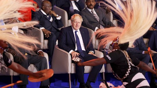 Ruffled: British Prime Minister Boris Johnson, centre, looks at traditional dancers performing during the opening ceremony of the Commonwealth Heads of Government Meeting (CHOGM) in Kigali, Rwanda.