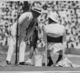  Referee Cliff Sproule speaking to American manager Frank Shields after halting play in the second set between Mervyn Rose and Ted Schroeder.