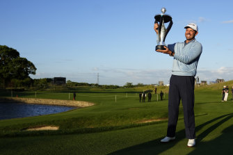 South African Charl Schwartzel poses with the trophy after winning the inaugural LIV Golf event.
