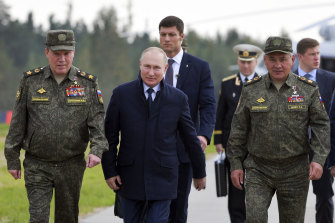 Russian President Vladimir Putin, Russian Defence Minister Sergei Shoigu, right, and Russian General Staff Valery Gerasimov, left, walk to attend the joint strategic Belarus exercise in the Nizhny Novgorod region of Russia.