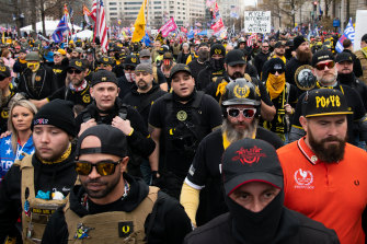 Demonstrators wearing Proud Boys attire during the protest march in Washington, D.C. on Saturday. The protests there, and in Washington state, later turned violent.