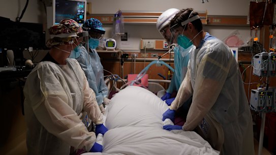 Medical workers prepare to move a COVID-19 patient at a hospital in Los Angeles.
