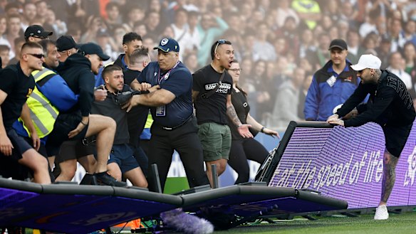 Fans storm the pitch during the match between Melbourne City and Melbourne Victory at AAMI Park.