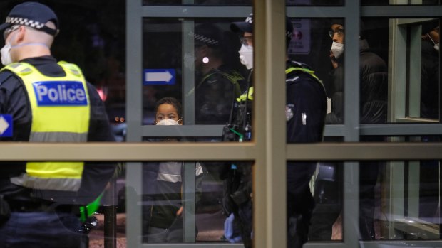 Police at the entrance of the Flemington public housing towers on Saturday night. 