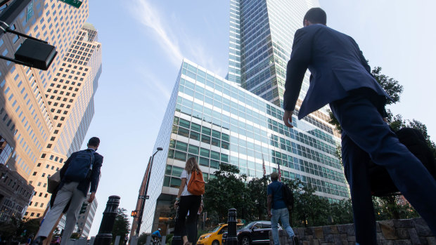 Office workers walk near the Goldman Sachs headquarters in New York.