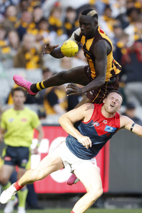 Mabior Chol of the Hawks competes with Steven May of the Demons in a marking contest.