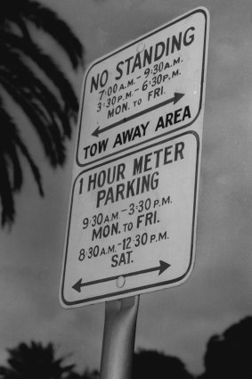  A sign in Macquarie Street indicating the tow-away area and restricted meter parking hours. July 1, 1958.