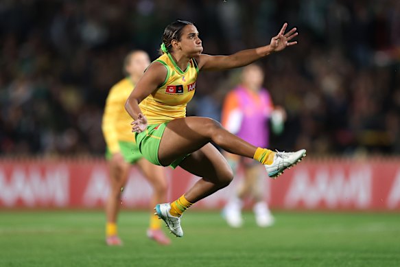 Courtney Hodder of Australia boots a goal.