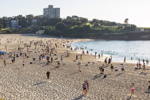Crowds flocked to Coogee on Saturday morning before the beach was closed at 9am.