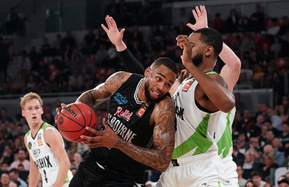 Shawn Long of Melbourne United drives to the basket during the season-opener against South East Melbourne Phoenix.
