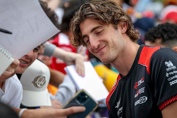 Haas reserve driver Jack Doohan smiles for supporters at the Melbourne Walk. 