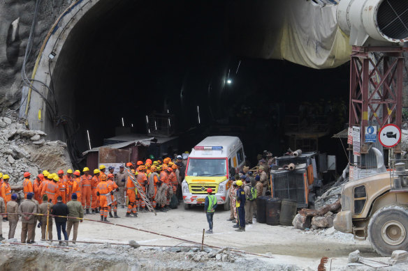 An ambulance waits to carry workers from the site of an under-construction road tunnel that collapsed 17 days ago.