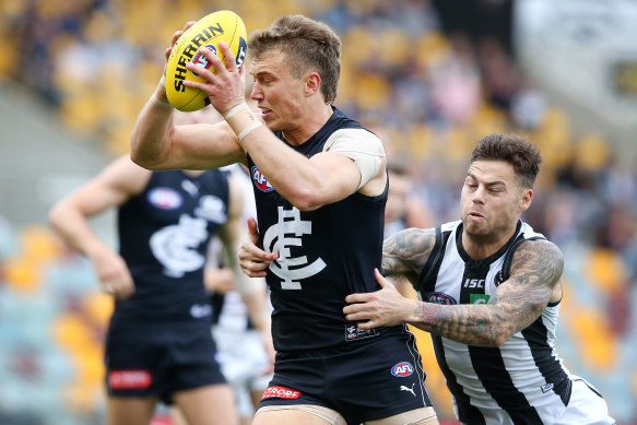 Caught short: Carlton's Patrick Cripps tries to evade a tackle from Collingwood's Jamie Elliott.