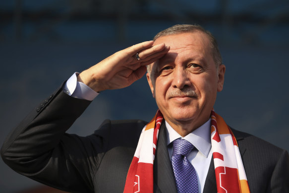Turkish President Recep Tayyip Erdogan gives a military salute toward his supporters during a rally in Kayseri, Turkey on Saturday.