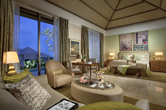 A private pool wraps around one half of the bedroom.