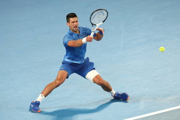Novak Djokovic, with strapping on his left leg, on the way to beating Tommy Paul in their semi-final.