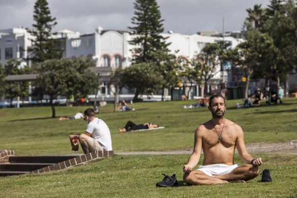 A man takes some time to meditate at Bondi Beach, Sydney on Friday.