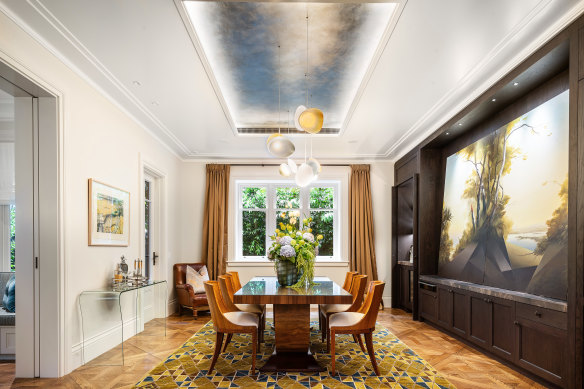 The house was rebuilt by Michael Walsh and designed by Weir Phillips Architects, and includes a dining room with a recessed ceiling detailed in gold leaf.