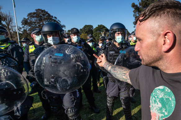 A protester confronts police.