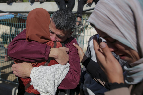 A freed Palestinian prisoner hugs a relative in Gaza.