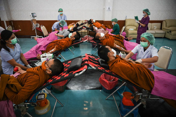 Buddhist monks donate blood for the victims.