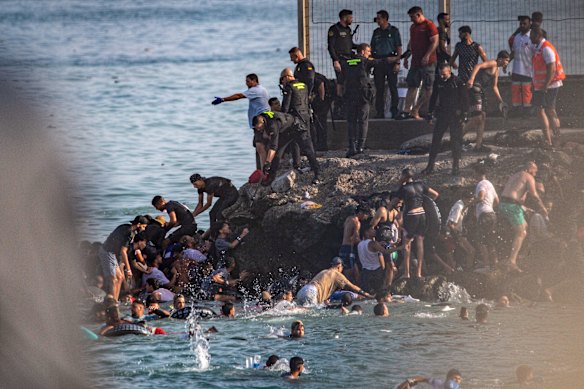 Migrants try to cross from Morocco into the Spanish enclave of Ceuta.