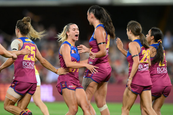 Jesse Wardlaw of the Lions celebrates kicking a goal with teammates during the AFLW Preliminary Final against the Adelaide Crows.