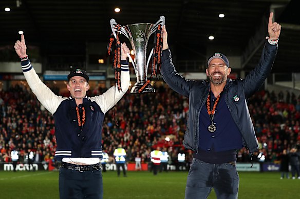Wrexham owners Rob Mac and Ryan Reynolds celebrate the club’s promotion in 2023.