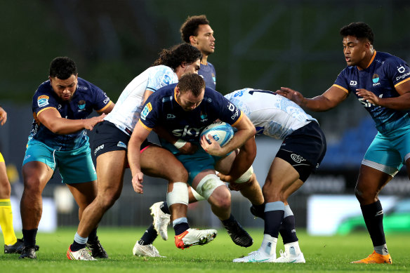 Allan Craig of Moana Pasifika is tackled. 