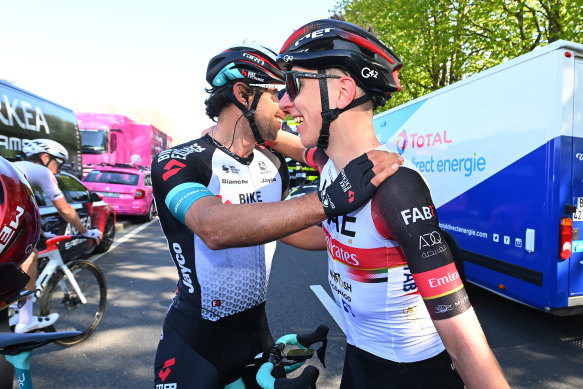 Australian Michael Matthews embraces Tadej Pogacar.