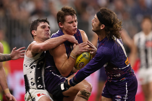 Caleb Serong of the Dockers gets tackled by Lachie Schultz of the Magpies.